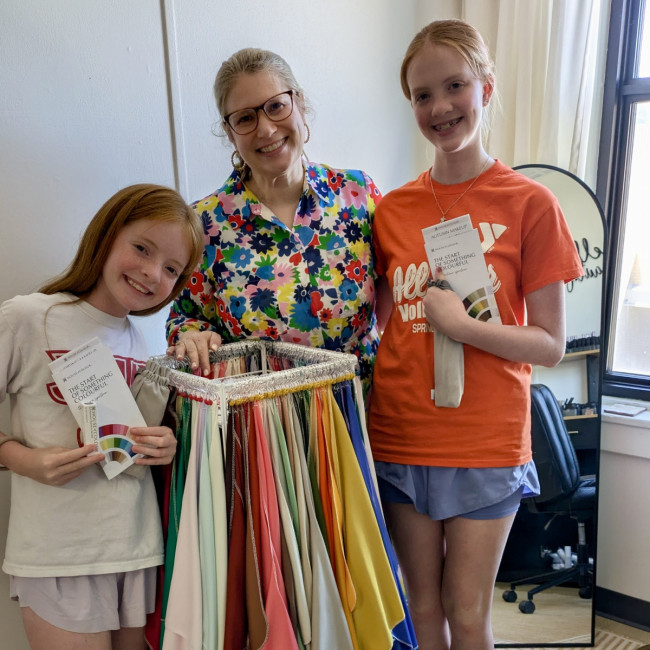 Girls smiling in front of drapes